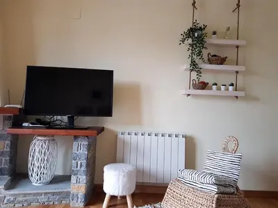 Una televisión o centro de entretenimiento en Family Duplex Esterri