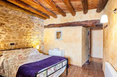Cama o camas de una habitación en Can Miqueló - casa rural 16 hòstes