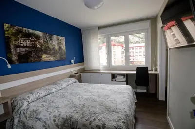 Cama o camas de una habitación en Pensión Ibai Ega