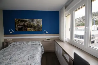 Cama o camas de una habitación en Pensión Ibai Ega