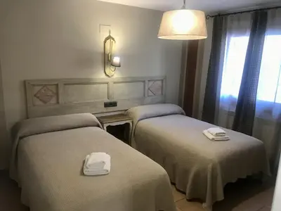 Cama o camas de una habitación en Apartamentos Blasco