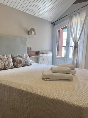 Cama o camas de una habitación en Apartamentos Blasco