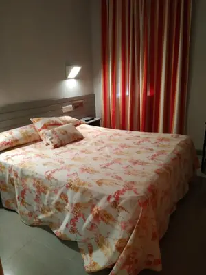 Cama o camas de una habitación en Hotel Fidalgo