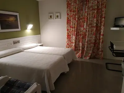 Cama o camas de una habitación en Hotel Fidalgo