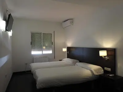 Cama o camas de una habitación en Hostal Meson de Paco