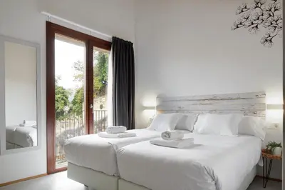 Cama o camas de una habitación en IRAIPE Estella Rooms Auto Check-in