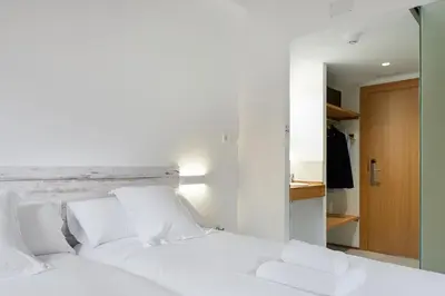 Cama o camas de una habitación en IRAIPE Estella Rooms Auto Check-in