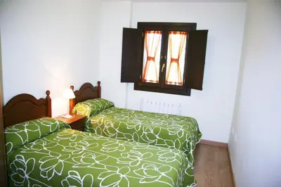 Cama o camas de una habitación en Apartamentos La Catedral