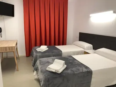Cama o camas de una habitación en Epsilon Alcañiz Hotel
