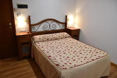Cama o camas de una habitación en Aparthotel Tres Caminos