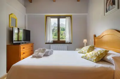 Cama o camas de una habitación en Alojamiento Escarrilla Pirineos