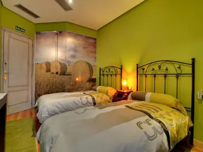 Cama o camas de una habitación en Hostal Rural Txapi Txuri Logis Hotels