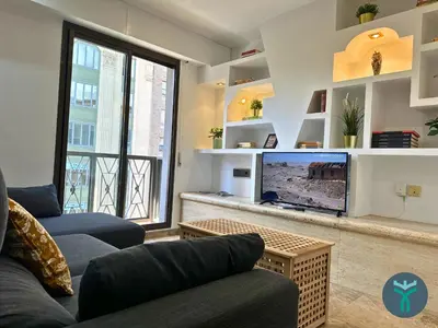 Una televisión o centro de entretenimiento en Dos Torres Ático Dúplex - Céntrico con Vistas a la Ciudad
