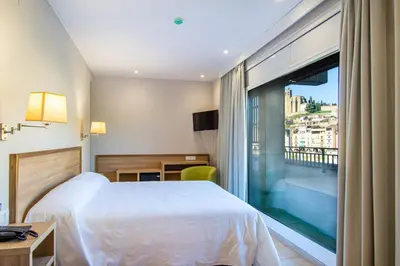 Cama o camas de una habitación en HOTEL JAUME D'URGELL