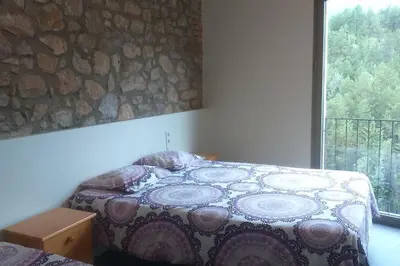 Cama o camas de una habitación en CASA SAPEIRÓ - Allotjament Rural