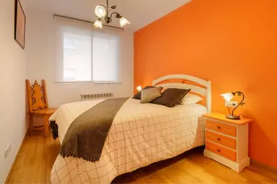 Cama o camas de una habitación en Apartamentos IRENE en el Pirineo Aragonés