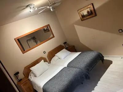 Cama o camas de una habitación en Hostal Arenal
