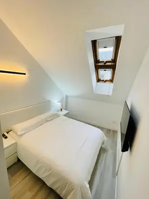 Cama o camas de una habitación en El Ático Nuevo en el centro con ascensor, garaje, aire acondicionado y WiFi