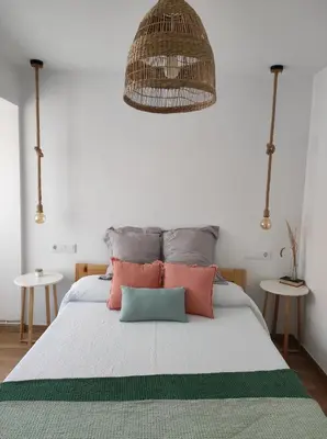 Cama o camas de una habitación en Apartamentos La Casa del Maestro