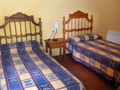 Cama o camas de una habitación en Hospedería Villa de Pintano
