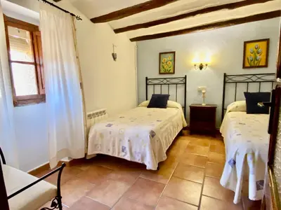 Cama o camas de una habitación en Casa Lola Beceite, terraza, barbacoa y chimenea