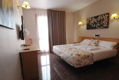 Cama o camas de una habitación en HOTEL MARIA ROSA