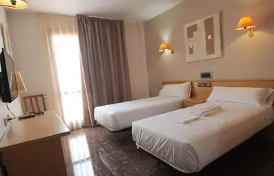 Cama o camas de una habitación en HOTEL MARIA ROSA