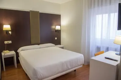 Cama o camas de una habitación en Hotel Delta
