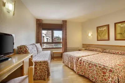 Cama o camas de una habitación en Hotel Nievesol