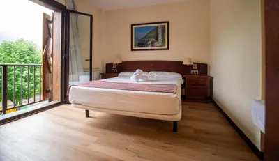 Cama o camas de una habitación en Hotel Romànic