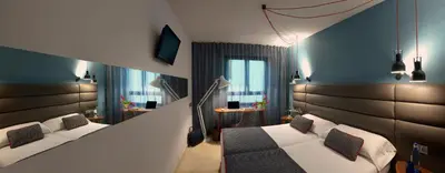 Cama o camas de una habitación en Hotel Pamplona Plaza